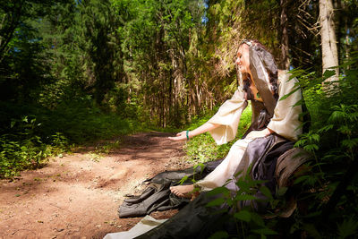 Portrait of woman standing in forest