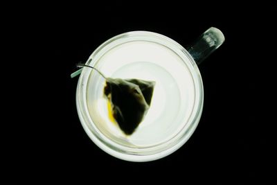 Directly above shot of tea cup against black background