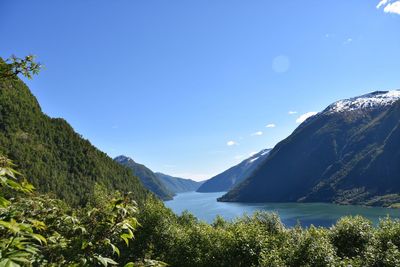 Scenic view of mountains against clear blue sky