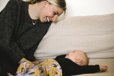 Young mother smiling to newborn baby