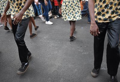 Low section of people dancing on street