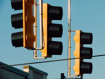 Low angle view of illuminated road against blue sky