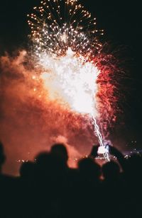 Low angle view of firework display at night