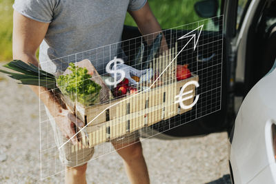 Financial chart and man carrying vegetables
