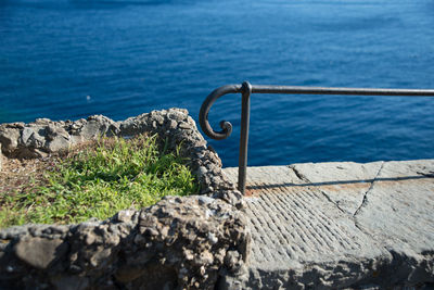 High angle view of railing by sea