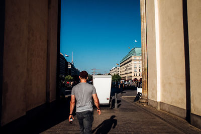 Woman standing against clear blue sky