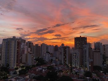 Modern buildings against sky during sunset in city