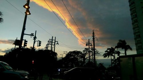 Low angle view of power lines against sky