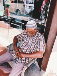 Rear view of man working on seat