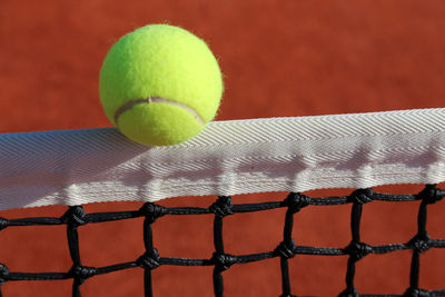 Close-up of yellow ball on the net 