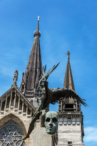 Low angle view of monument and manizales cathedral against sky