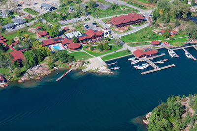 High angle view of houses and trees by sea