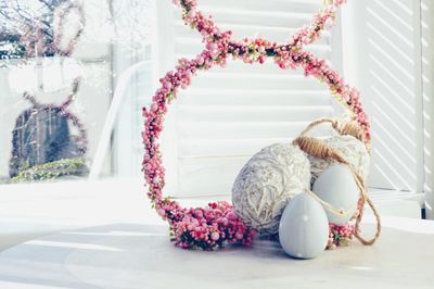 Easter eggs with pink buds on table