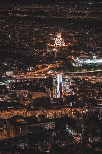 High angle view of city lit up at night