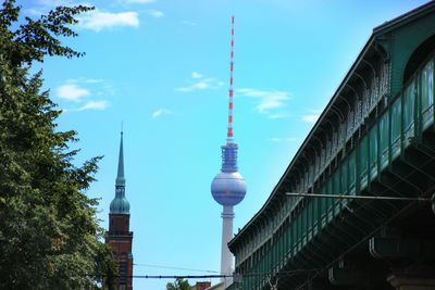 Low angle view of communications tower against sky