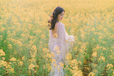 Side view of woman standing on field