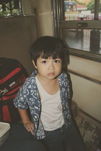 Portrait of boy sitting in train