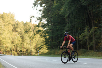 Man riding bicycle on road