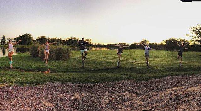 grass, clear sky, field, large group of people, leisure activity, lifestyles, men, tree, copy space, grassy, person, green color, landscape, park - man made space, nature, sky, sport, outdoors, walking