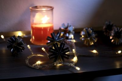 Close-up of illuminated candles on table