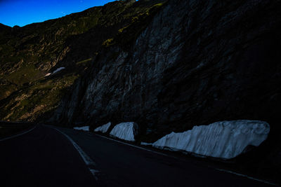 Road leading towards mountain against sky