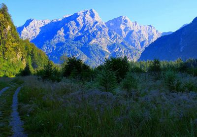 Scenic view of mountains against blue sky
