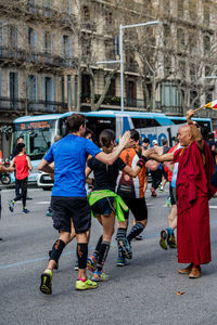 People on road against built structures