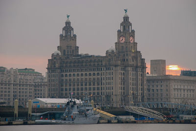 View of buildings in city against sky during sunset