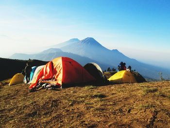 Tent on field by mountain against sky