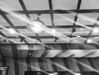 Low angle view of illuminated pendant lights hanging from ceiling