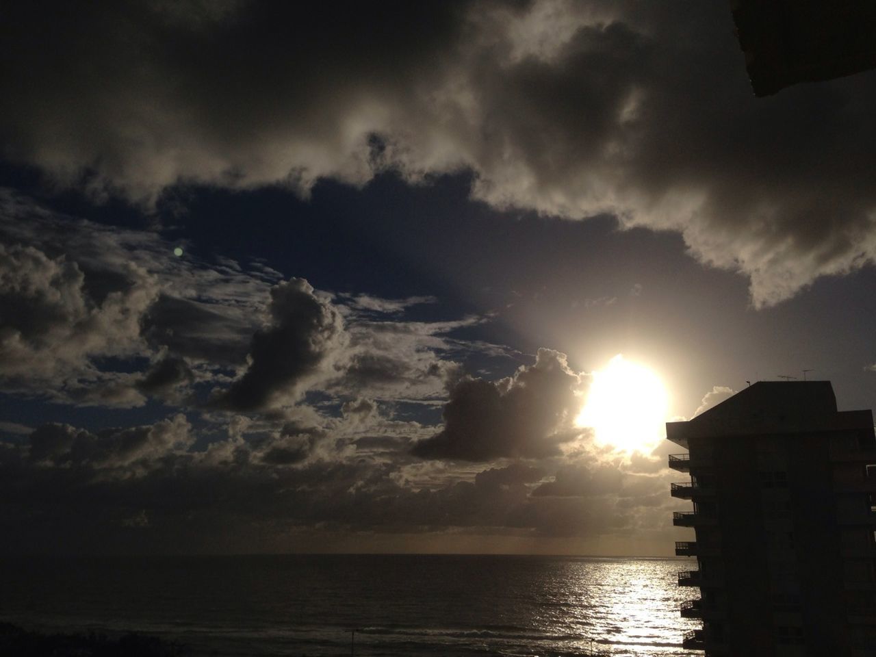 water, sky, sea, sunset, waterfront, cloud - sky, sun, scenics, beauty in nature, building exterior, architecture, built structure, horizon over water, tranquil scene, tranquility, nature, silhouette, cloud, reflection, idyllic