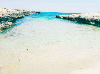 Scenic view of beach against clear sky