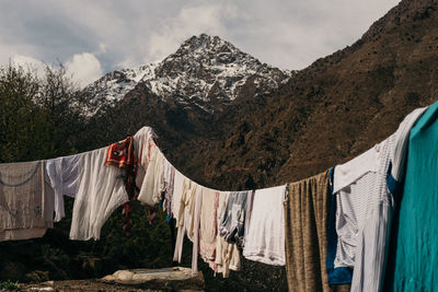 Clothes drying on clothesline against mountains