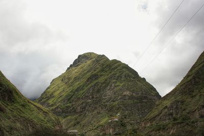 Scenic view of mountains against cloudy sky