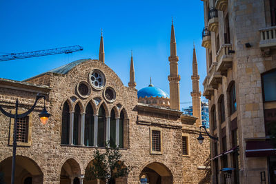 Low angle view of buildings against blue sky