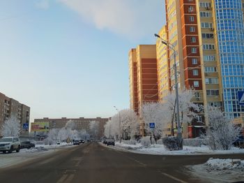 Street amidst buildings in city against sky