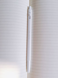 Close-up of open book and pen