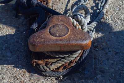 High angle view of rusty chain on rock