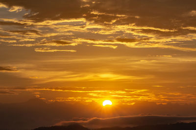 Low angle view of dramatic sky during sunset