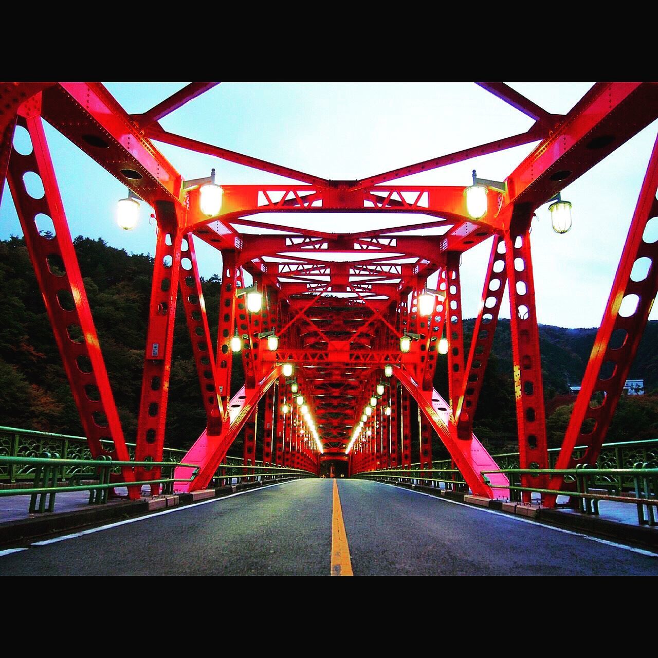 built structure, red, architecture, connection, bridge - man made structure, engineering, metal, clear sky, sky, low angle view, transportation, travel destinations, famous place, bridge, travel, metallic, illuminated, the way forward, outdoors, no people