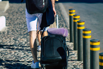 Low section of man walking on road