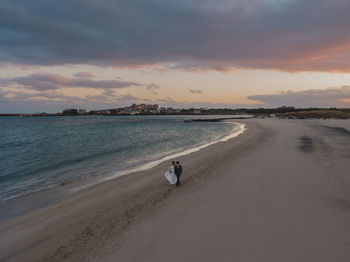 Scenic view of beach against sky during sunset