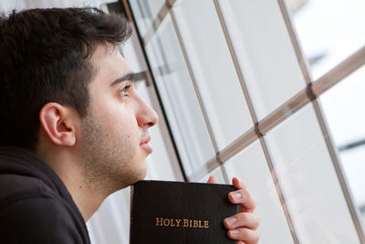 Close-up portrait of young man looking away