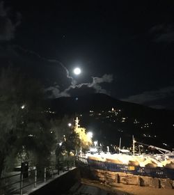 Illuminated lights against sky at night