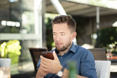 Man using phone while sitting at restaurant