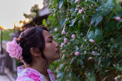 Portrait of woman with pink flowers