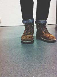 Low section of woman standing on tiled floor