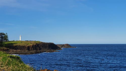 Scenic view of sea against clear blue sky. kiama lighthouse