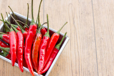 Close-up of red chili peppers on table