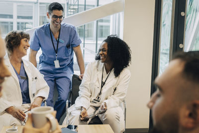 Happy multiracial healthcare workers during coffee break in hospital